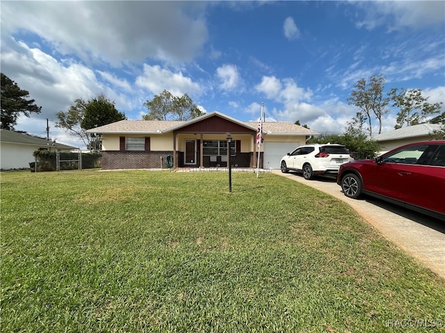 single story home with a front yard and a garage