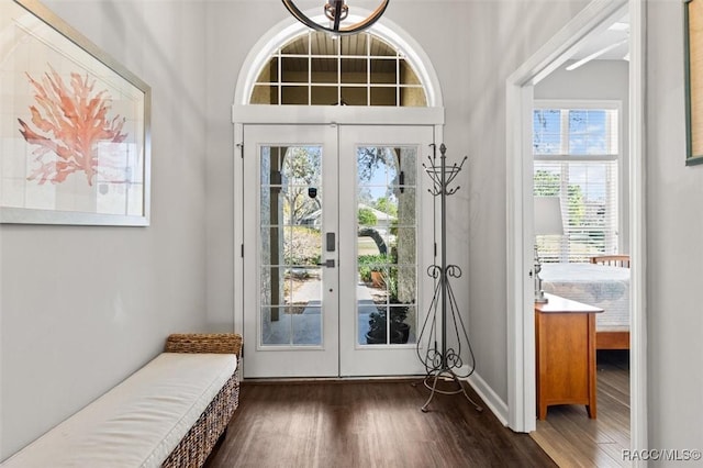 entryway featuring baseboards and dark wood finished floors