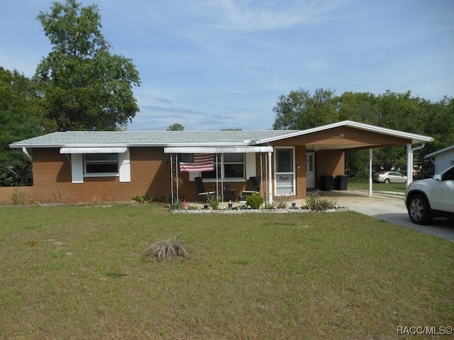 single story home featuring a front lawn, driveway, and a carport