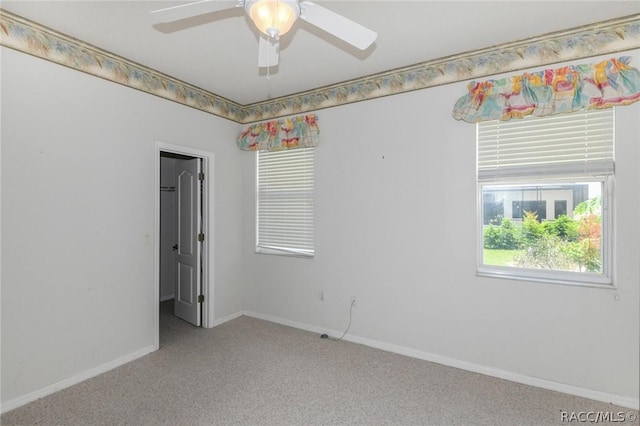 carpeted empty room featuring ceiling fan