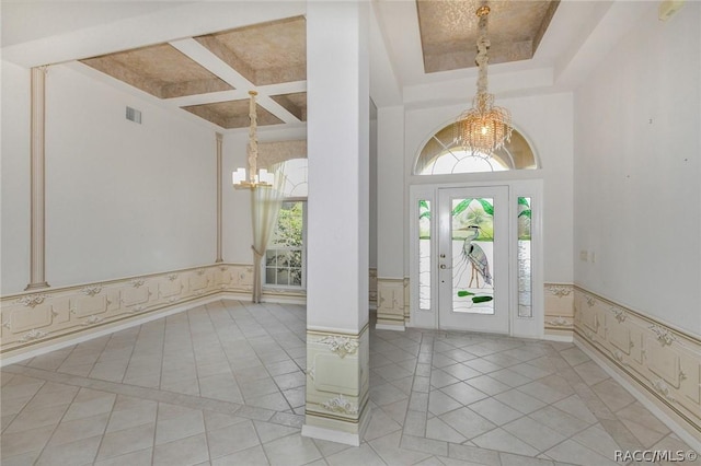 entryway featuring a tray ceiling, beamed ceiling, coffered ceiling, and a notable chandelier