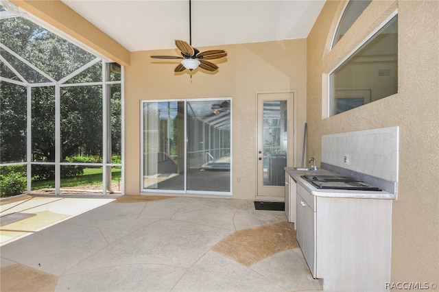 view of patio with ceiling fan and sink