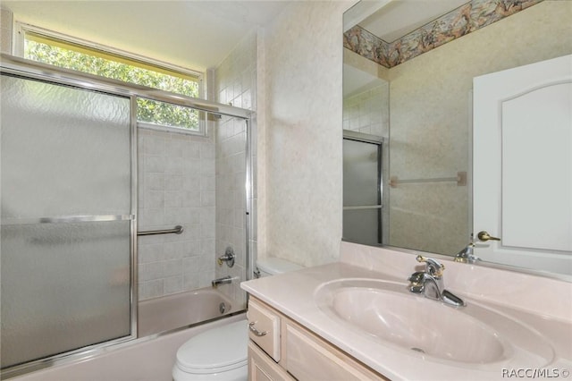 full bathroom with vanity, toilet, and enclosed tub / shower combo