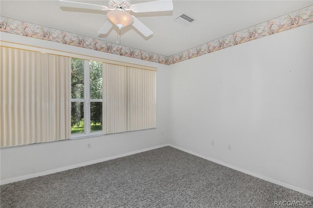 carpeted empty room featuring ceiling fan