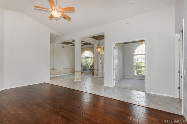 empty room featuring ceiling fan, light hardwood / wood-style flooring, and lofted ceiling