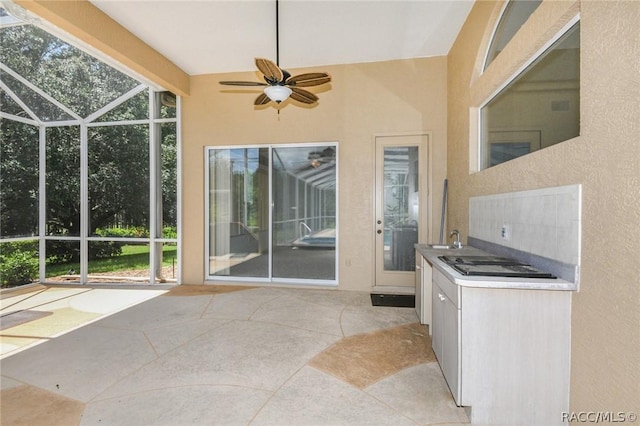 view of patio with ceiling fan, sink, and exterior kitchen