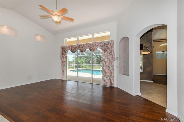 unfurnished room with dark hardwood / wood-style flooring, vaulted ceiling, and ceiling fan