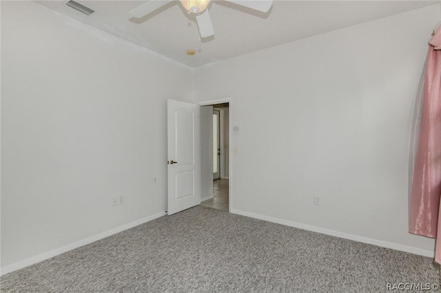 spare room featuring ceiling fan and carpet