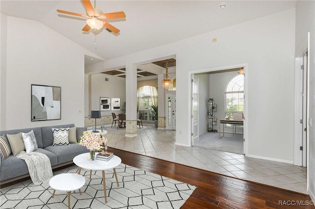 living room with ceiling fan, light hardwood / wood-style floors, and lofted ceiling