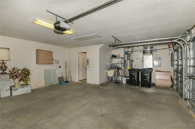 garage featuring gas water heater, a garage door opener, and sink