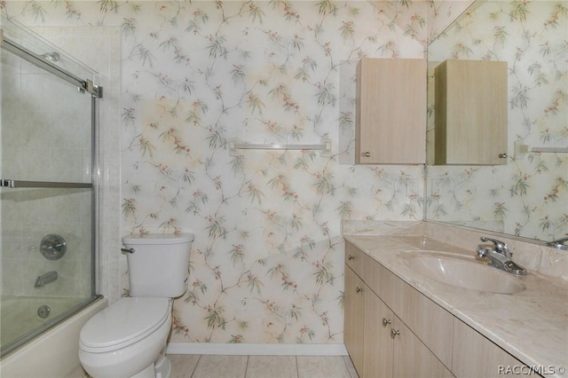 full bathroom with tile patterned flooring, vanity, toilet, and enclosed tub / shower combo