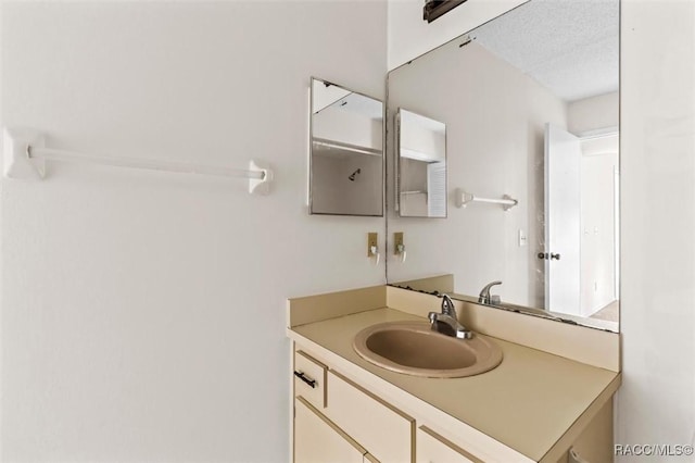 bathroom with vanity and a textured ceiling