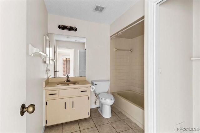 full bathroom with tiled shower / bath combo, vanity, toilet, tile patterned floors, and a textured ceiling