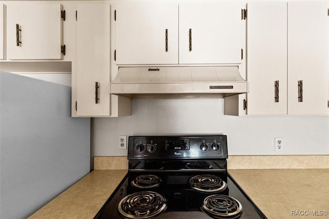 kitchen with white cabinets, electric range, and exhaust hood