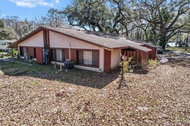 rear view of property with central AC unit