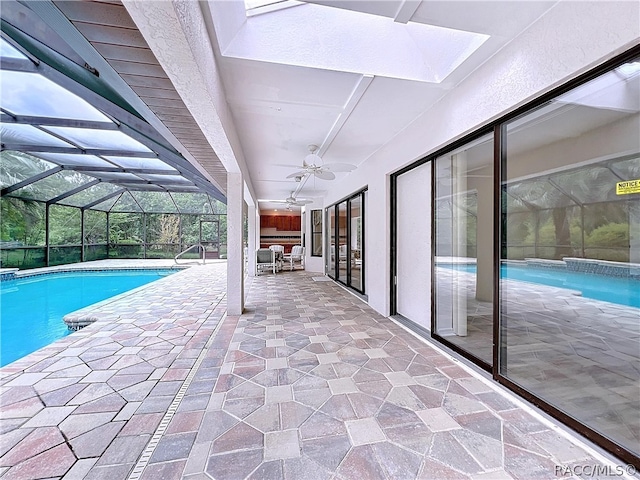 view of swimming pool featuring an outdoor hangout area, glass enclosure, ceiling fan, and a patio area