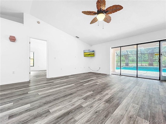 unfurnished living room featuring ceiling fan, lofted ceiling, and hardwood / wood-style flooring