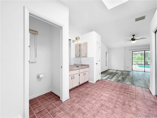 bathroom with tasteful backsplash, ceiling fan, vanity, and wood-type flooring