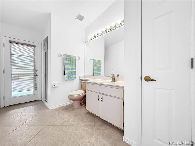 bathroom featuring tile patterned flooring, vanity, lofted ceiling, and toilet