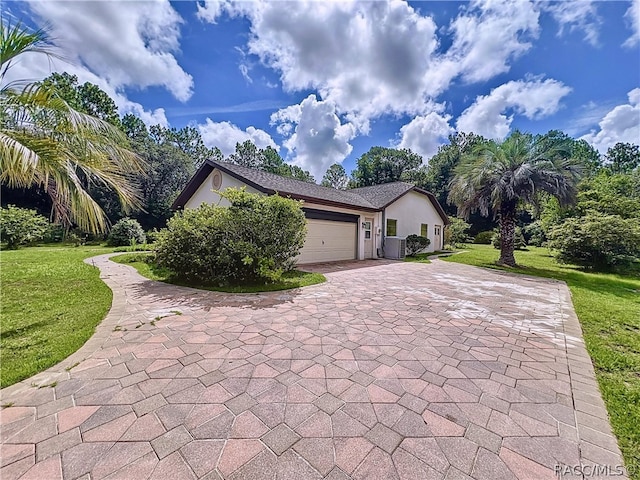 view of front of home featuring a garage and a front lawn