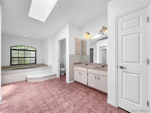 bathroom featuring tile patterned floors, a bathtub, vanity, and toilet