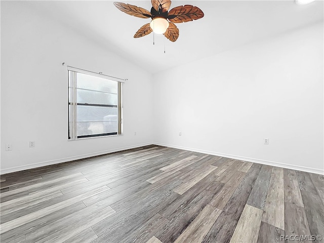 empty room with ceiling fan, light hardwood / wood-style floors, and lofted ceiling