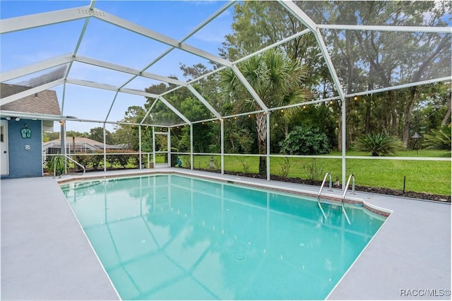 view of swimming pool with a yard, glass enclosure, and a patio