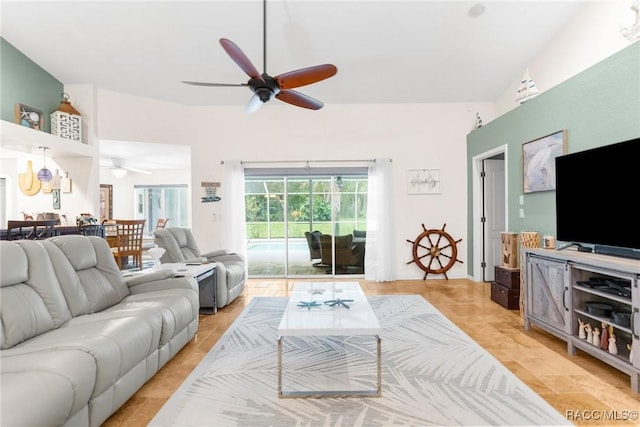 living room featuring ceiling fan and lofted ceiling