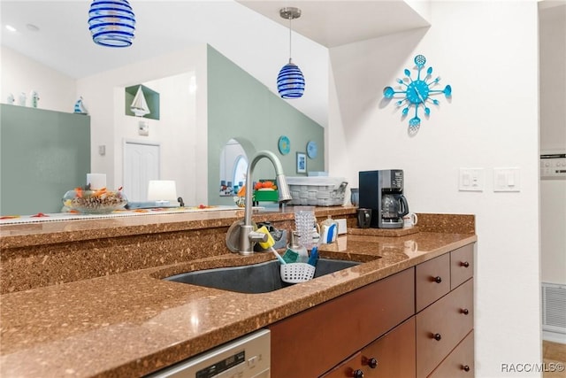 kitchen with sink, stone countertops, decorative light fixtures, and dishwasher