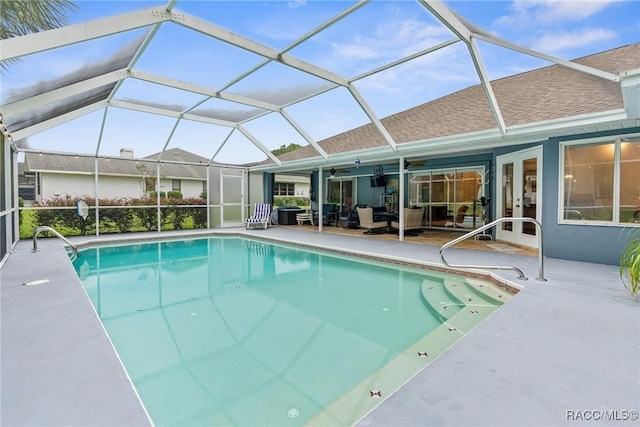 view of pool with ceiling fan, a patio area, and glass enclosure