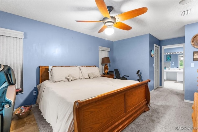 carpeted bedroom with a textured ceiling, ceiling fan, and a closet