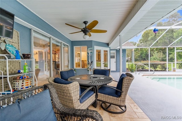 sunroom / solarium featuring ceiling fan and a pool