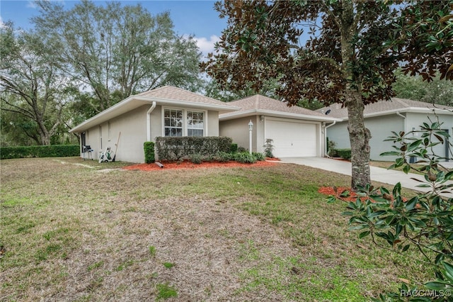 ranch-style house with a garage and a front lawn