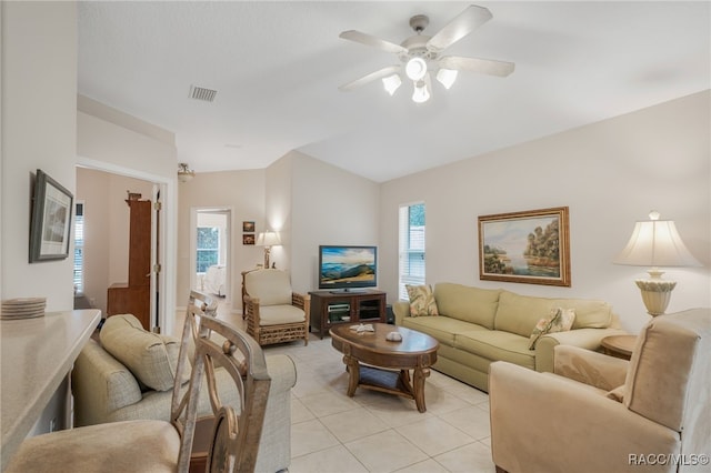 tiled living room with ceiling fan and lofted ceiling