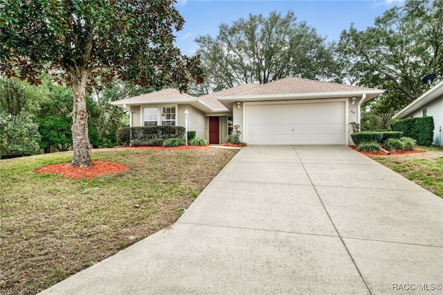 view of front facade featuring a garage and a front lawn