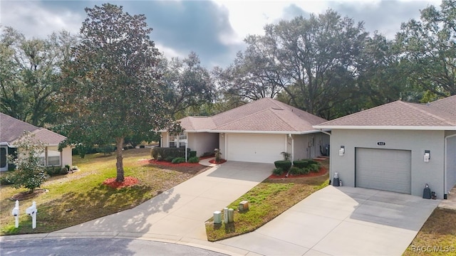 ranch-style home with a garage and a front lawn