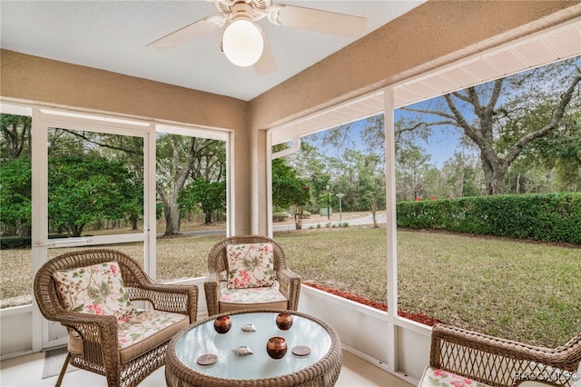 sunroom / solarium featuring ceiling fan