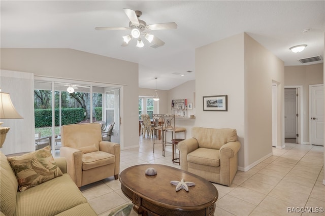 tiled living room with lofted ceiling and ceiling fan