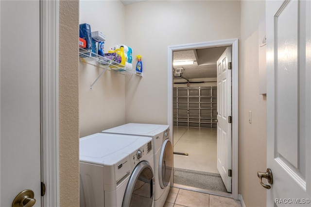 washroom with light tile patterned flooring and washing machine and dryer