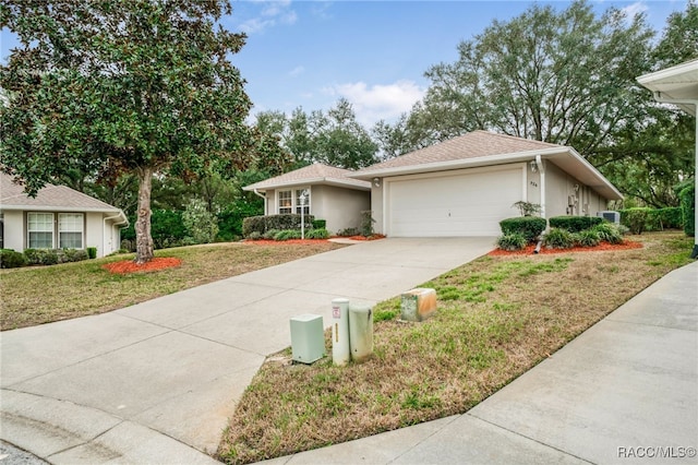 single story home featuring a garage and a front lawn