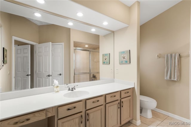 bathroom with tile patterned floors, vanity, toilet, and a shower with shower door