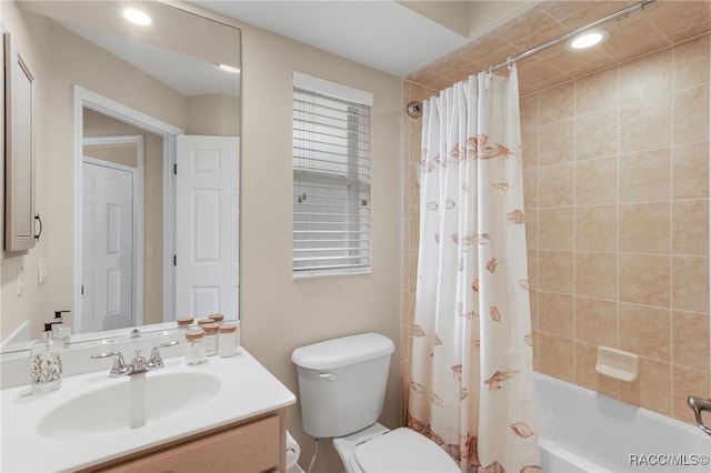 full bathroom featuring shower / tub combo with curtain, vanity, and toilet