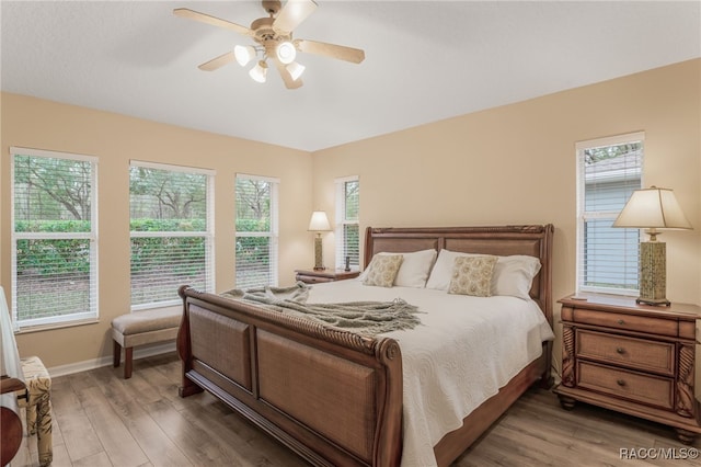 bedroom with ceiling fan and dark hardwood / wood-style flooring