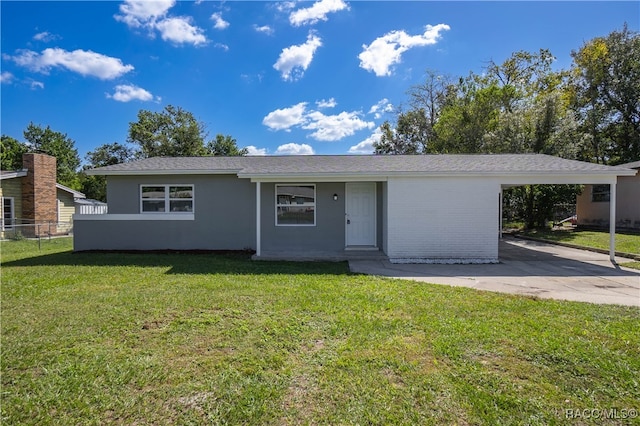 ranch-style home with a front lawn and a carport