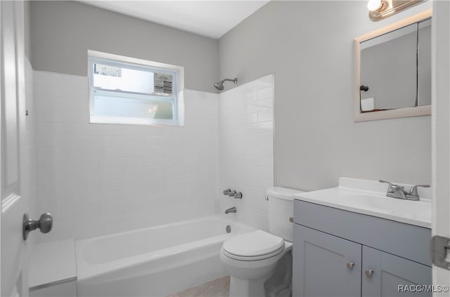 full bathroom with toilet, vanity, and tiled shower / bath