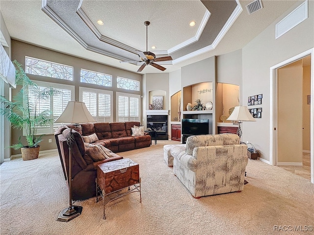 4339 N Canarywood Ter, Beverly Hills, FL 34465 - carpeted living room featuring ceiling fan, ornamental molding, a tray ceiling, and a high ceiling