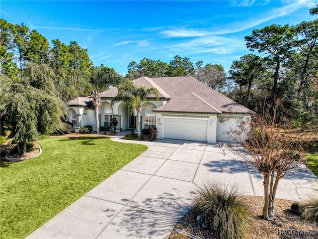 view of front of property with a garage and a front yard