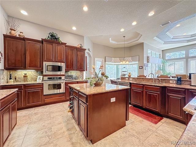 4339 N Canarywood Ter, Beverly Hills, FL 34465 - kitchen featuring pendant lighting, sink, stainless steel appliances, a kitchen island, and a raised ceiling