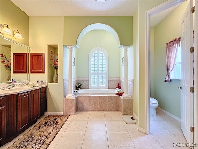 4339 N Canarywood Ter, Beverly Hills, FL 34465 - bathroom featuring tile patterned floors, toilet, decorative columns, and tiled tub
