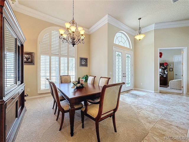 4339 N Canarywood Ter, Beverly Hills, FL 34465 - dining room with a towering ceiling, a chandelier, ornamental molding, a textured ceiling, and french doors
